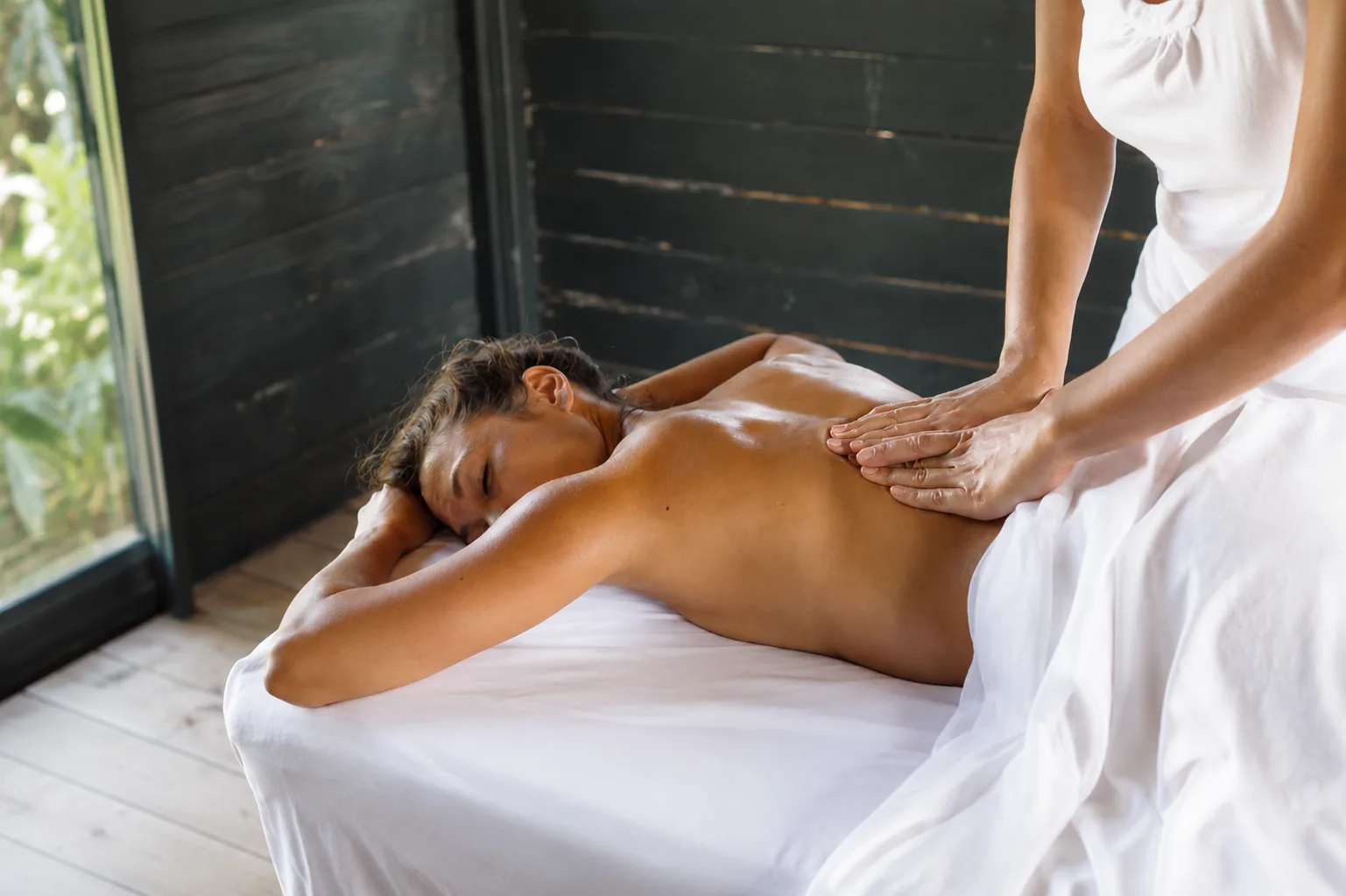A calming massage treatment in a light-filled Maui retreat room